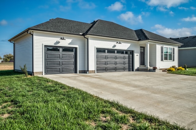 ranch-style home featuring a garage and a front lawn