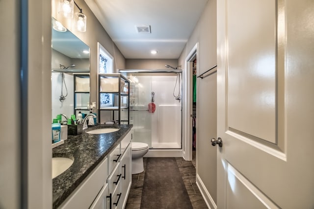 bathroom featuring hardwood / wood-style floors, vanity, toilet, and walk in shower