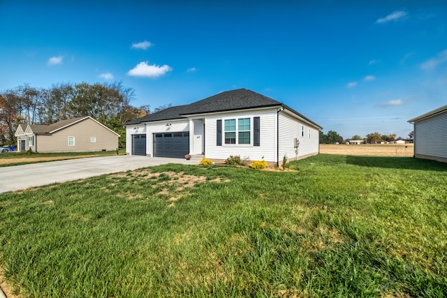 view of front of house featuring a front yard and a garage