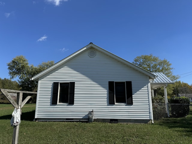 view of side of home featuring a yard