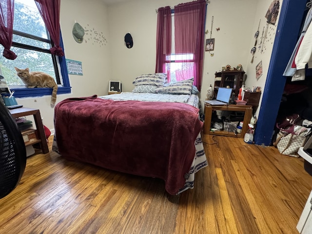 bedroom with hardwood / wood-style floors