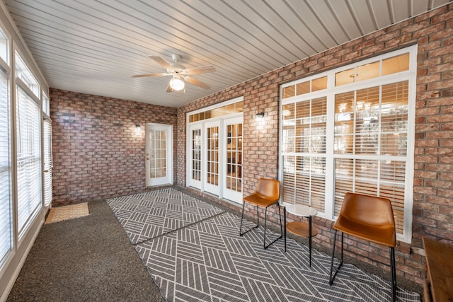 unfurnished sunroom featuring french doors and ceiling fan