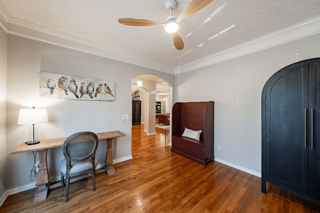 home office with ceiling fan, hardwood / wood-style floors, a textured ceiling, and ornamental molding