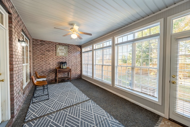 sunroom / solarium featuring ceiling fan