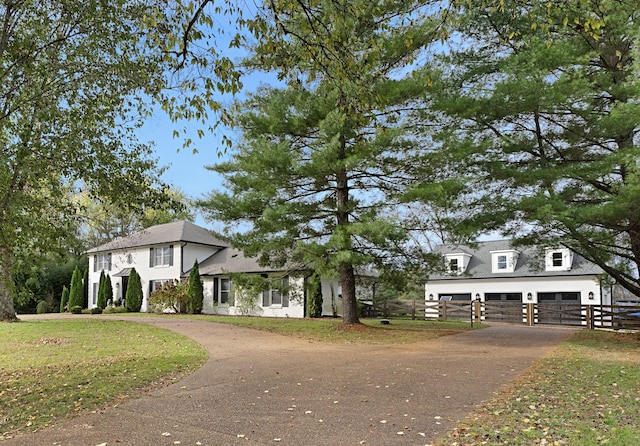 view of front of property with a front yard and a garage