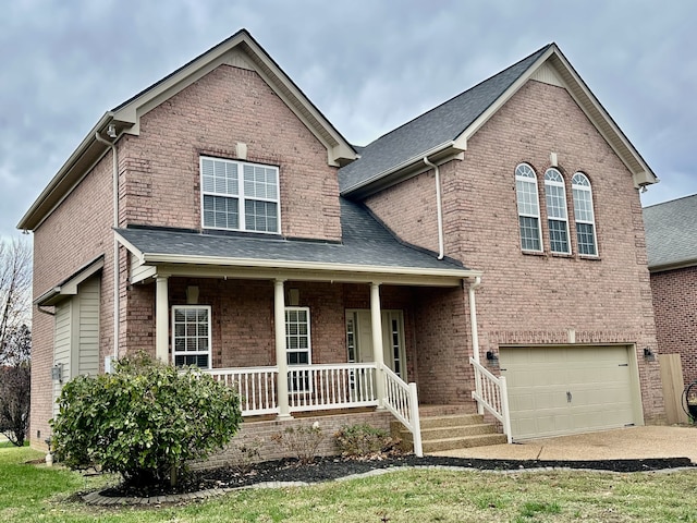 view of front of property with a porch and a garage