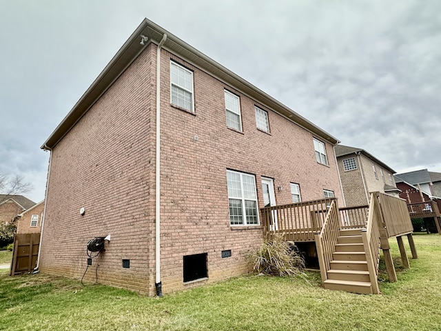 rear view of house with a lawn and a deck