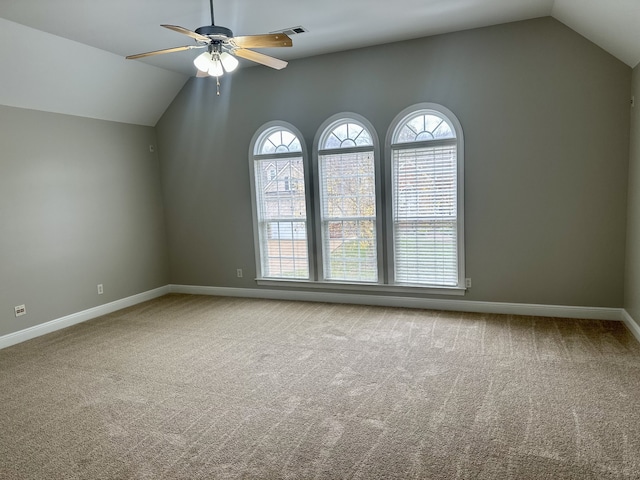 spare room featuring carpet, ceiling fan, and lofted ceiling