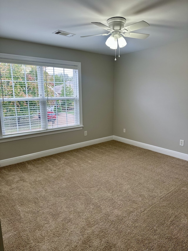 carpeted empty room featuring ceiling fan