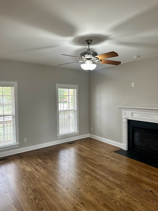 unfurnished living room featuring dark hardwood / wood-style floors and ceiling fan