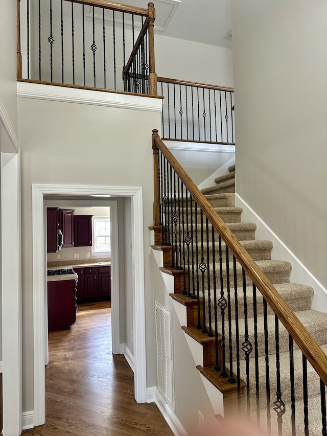 stairway with hardwood / wood-style flooring