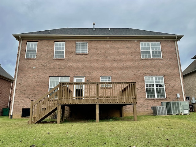 rear view of house with central air condition unit, a yard, and a deck