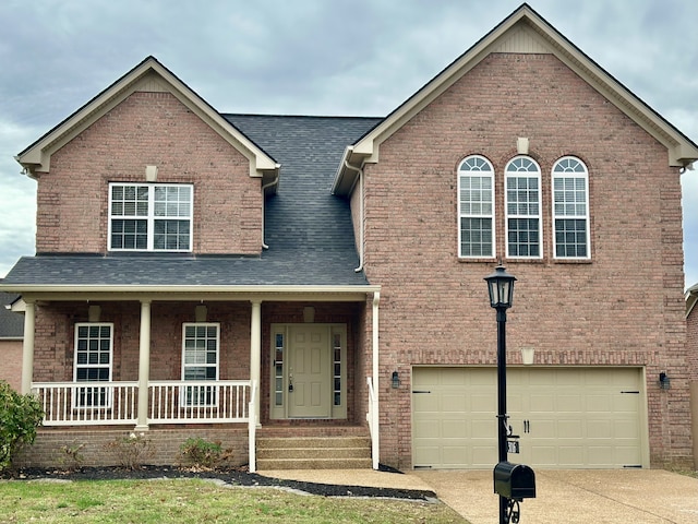 view of front of house featuring covered porch and a garage