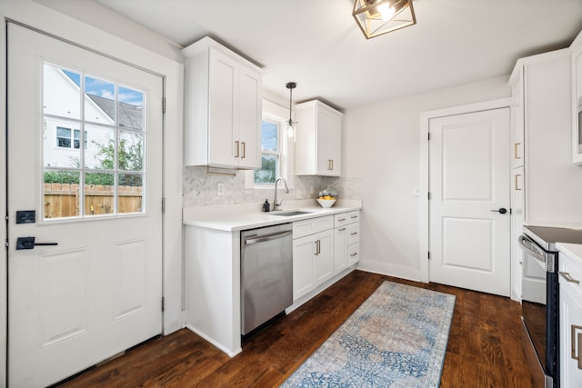 kitchen featuring dishwasher, decorative light fixtures, plenty of natural light, and sink