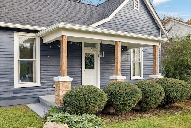 view of exterior entry featuring covered porch