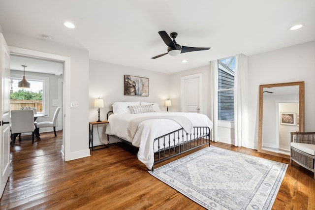 bedroom with ceiling fan and dark hardwood / wood-style floors