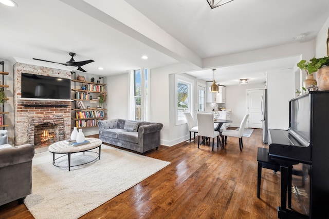 living room featuring a fireplace, ceiling fan, and hardwood / wood-style floors