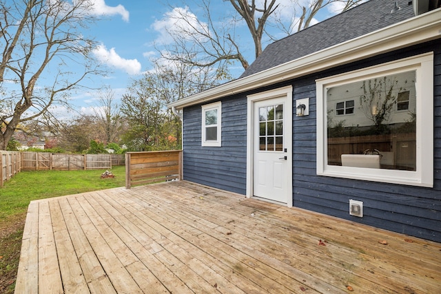 wooden terrace featuring a lawn