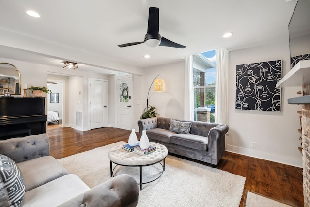 living room with dark hardwood / wood-style floors and ceiling fan