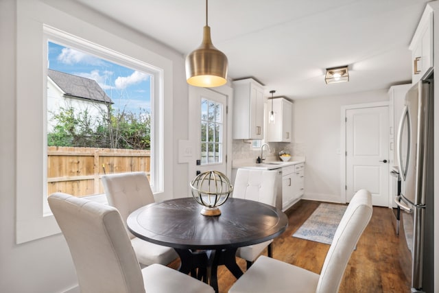 dining area featuring dark hardwood / wood-style flooring and sink