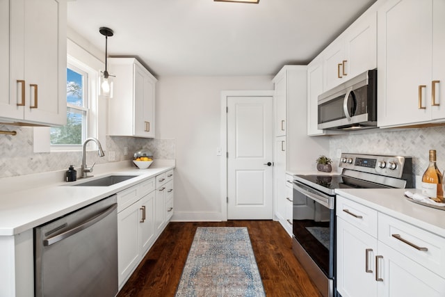 kitchen with white cabinets, sink, appliances with stainless steel finishes, and dark wood-type flooring