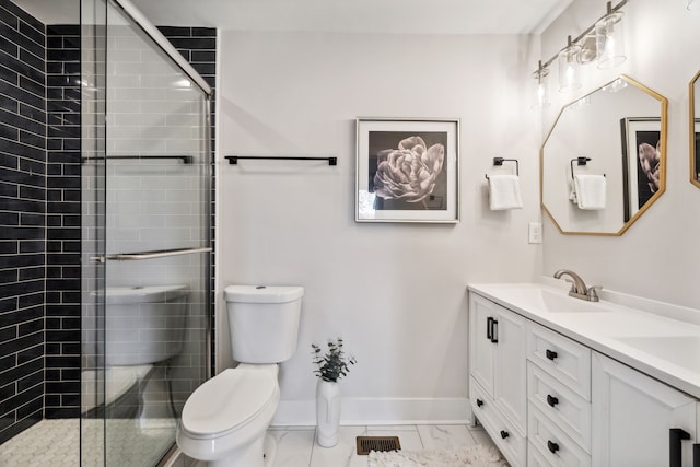 bathroom with a shower with door, vanity, and toilet