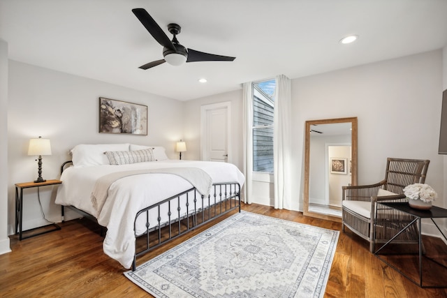 bedroom with ceiling fan and dark hardwood / wood-style floors