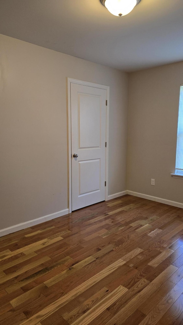 empty room with dark hardwood / wood-style floors