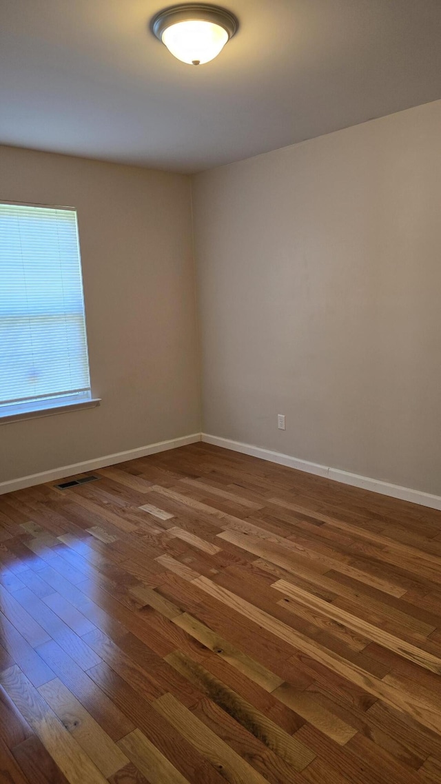 spare room featuring dark hardwood / wood-style flooring