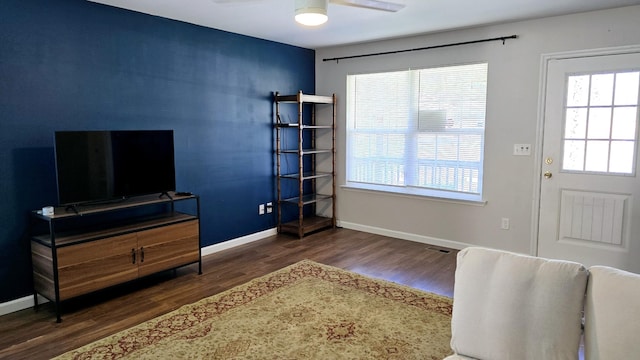 interior space featuring ceiling fan and dark hardwood / wood-style floors