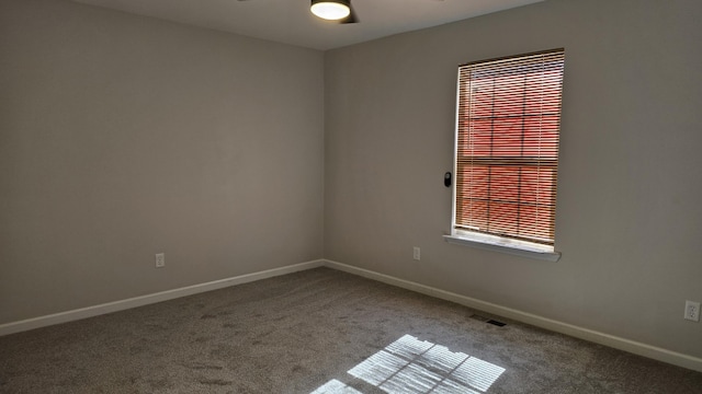 empty room featuring carpet and ceiling fan