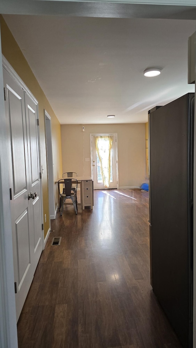 hall with dark wood-type flooring