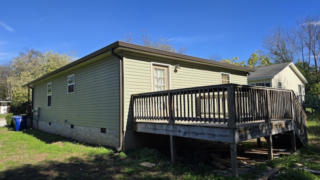 rear view of property with a wooden deck