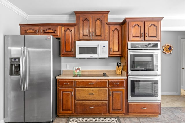 kitchen with stainless steel appliances, ornamental molding, and light tile patterned flooring