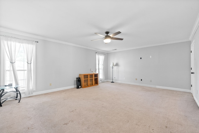 carpeted empty room with ceiling fan and ornamental molding