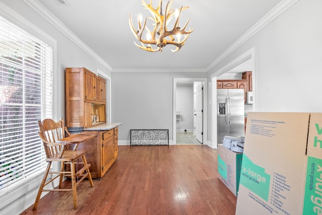 interior space featuring crown molding, dark hardwood / wood-style floors, and a notable chandelier