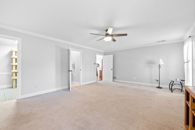 interior space featuring ceiling fan, ornamental molding, and light carpet