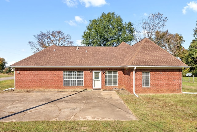 back of property with a yard and a patio