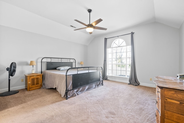 bedroom with ceiling fan, light carpet, and vaulted ceiling