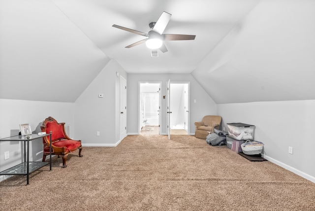 interior space with ceiling fan, carpet floors, and lofted ceiling