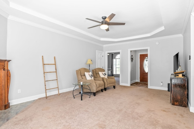 sitting room with light colored carpet, a raised ceiling, ceiling fan, and ornamental molding