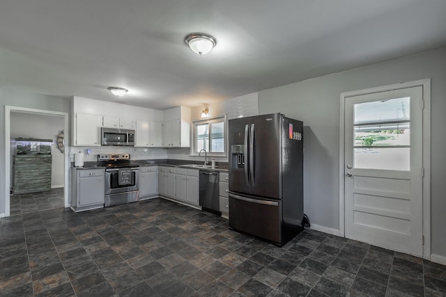 kitchen featuring white cabinets, stainless steel appliances, and sink