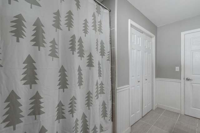 bathroom featuring a shower with curtain and tile patterned flooring