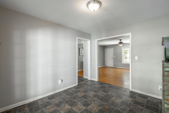 spare room with ceiling fan and dark hardwood / wood-style flooring