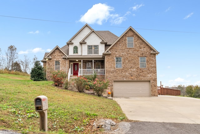 view of front of property featuring a front yard, a porch, and a garage