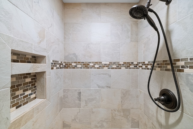 bathroom with a tile shower