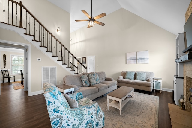 living room featuring ceiling fan, high vaulted ceiling, and dark wood-type flooring