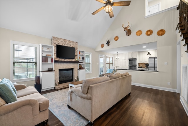 living room with a fireplace, dark hardwood / wood-style flooring, high vaulted ceiling, and ceiling fan