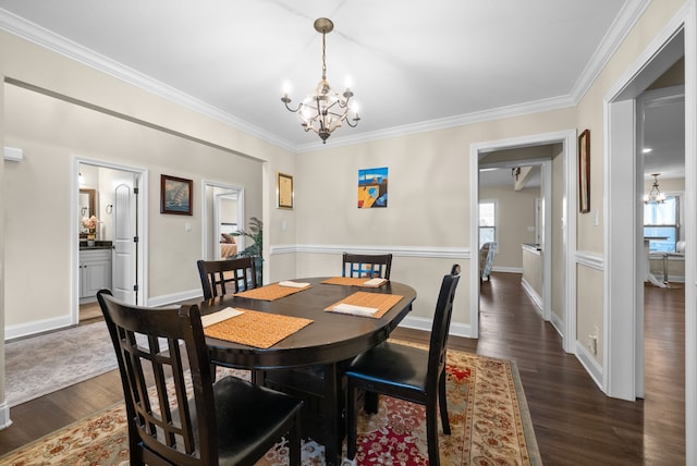 dining space featuring dark hardwood / wood-style floors, a healthy amount of sunlight, and ornamental molding