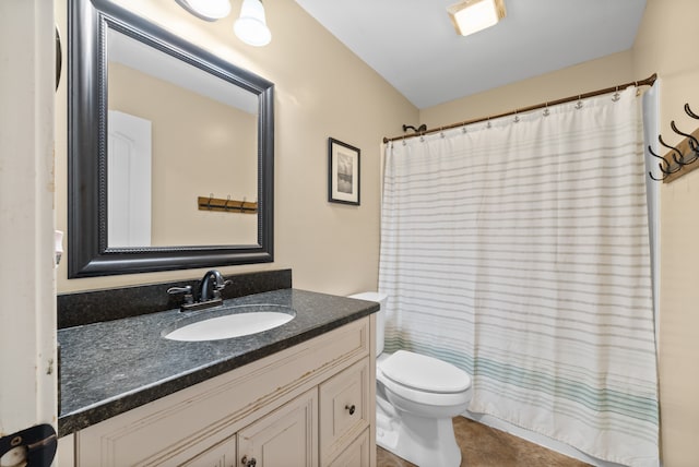 bathroom featuring vanity, toilet, and walk in shower